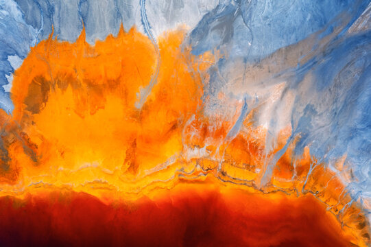 Top view of abstract rivers with vibrant orange and blue colors 