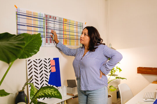 Hispanic woman working in modern office