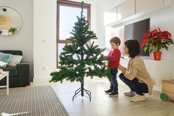 Mother and son decorating a Christmas tree
