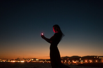 Surreal portrait of a smiling woman using smartphone