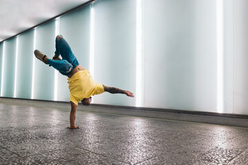 Young man doing a handstand and breakdancing