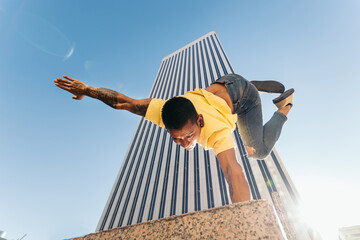 Gymnast doing a handstand in an urban area with skyscrapers