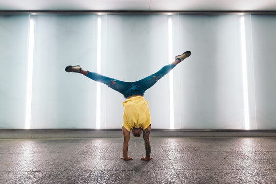 Young man doing a handstand and breakdancing