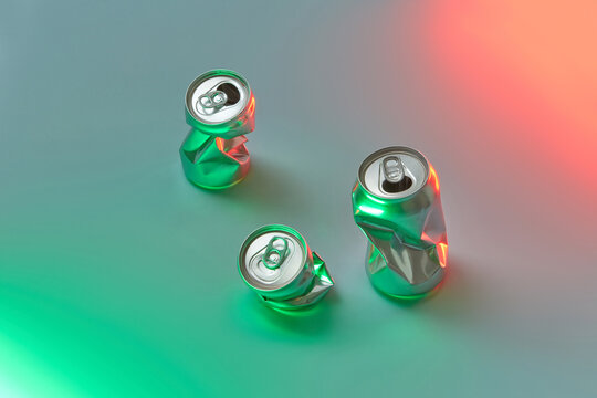 Crushed aluminum cans on neon background.