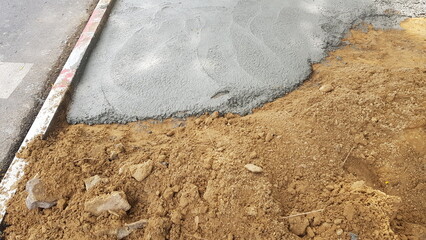 Pour the cement onto the compacted path to be a walkway.
