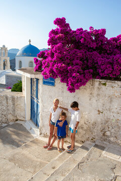 Mother with her kid walking in a small Mediterranean village in Greece