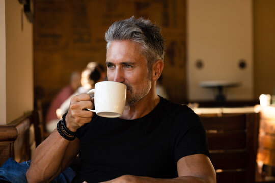 Mature man with cup of coffee