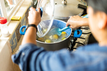 Woman cooking fresh vegetables in her kitchen