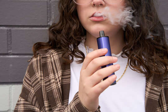 Young person using vape pen