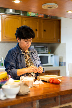 Woman peeling fresh garlic for cooking