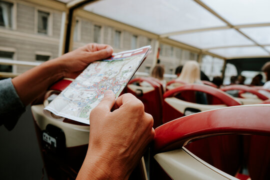 man consulting a map on a tour bus