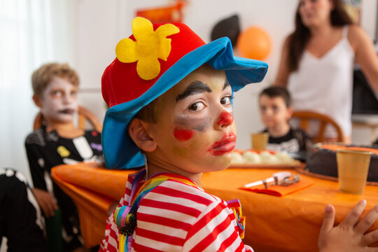 Children in halloween outfirs at party table