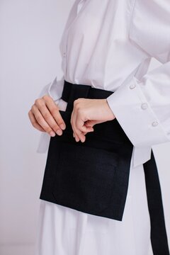 Crop woman zipping black bag
