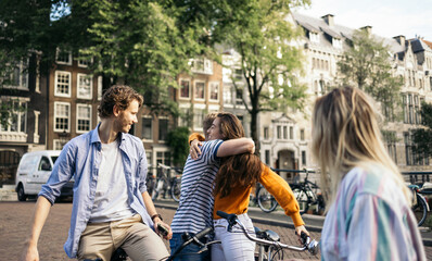 Group of happy friends greeting each other