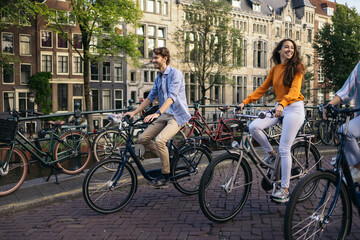 Young people riding bikes in Amsterdam