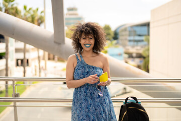 Smiling black lady standing on bridge in city district