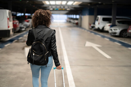 Back view of traveler in rent car garage