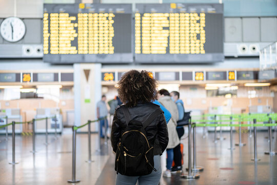 Female traveler reading departure board