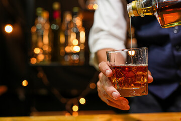 Bartender pouring Whiskey, on  bar,