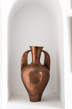 Old copper vase in alcove