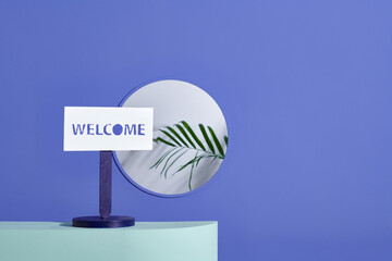 A sign reads "Welcome" on a color table in a coffee shop