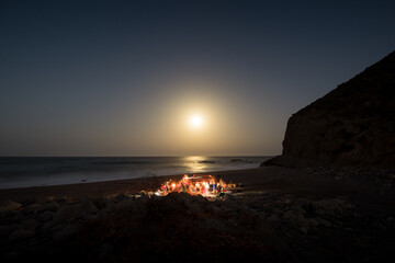 Family enjoying night picnic at the beach