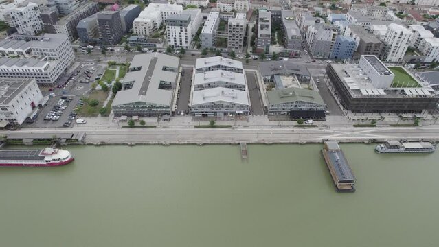 Top of Bassins &agrave; Flots buildings in Bordeaux France with restaurant floating ship in red and white, Aerial dolly right shot