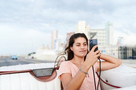 Woman talking selfies in a vintage car