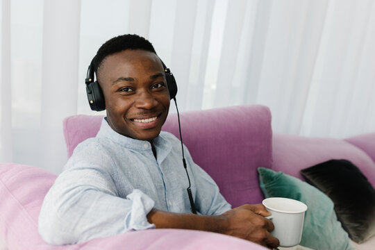 A man  with a cup of tea at home