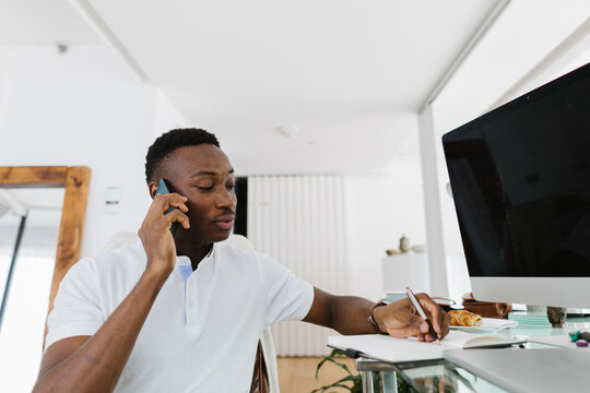 A man  working and talking on the phone
