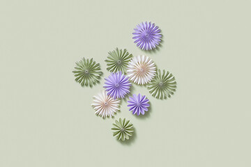 Colorful papercraft flowers on pastel background.