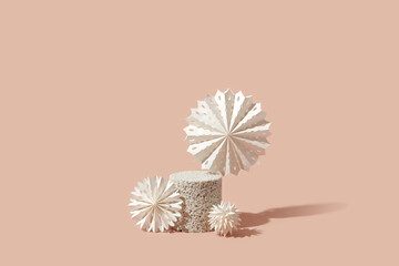 White paper snowflakes on stone stand.