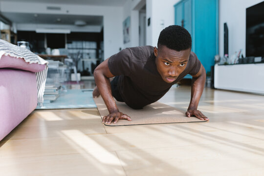 Man doing push ups indoors