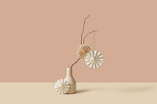 Tender paper ornament on branch in stylish vase.