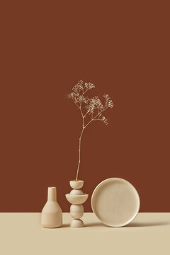 Stylish vase and plate decorated with dry branch.