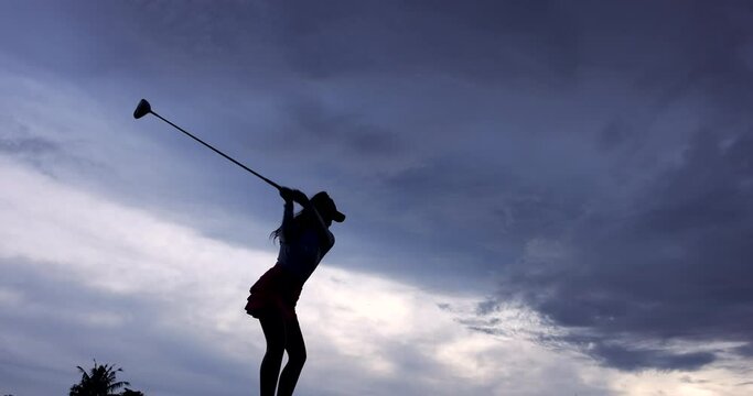 Silhouette Asian female golfer Swing Drive Golf, wide angle slow motion 4k video