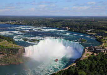 Fototapeta premium Aerial view of Horseshoe Falls including Hornblower Boat sailing on Niagara River, Canada and USA natural border