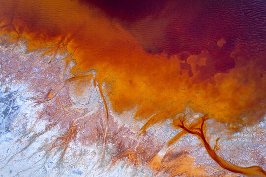 Abstract flowing rivers on vibrant orange, blue, red colors. Top view