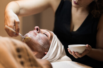 Woman in mask on face in spa beauty salon