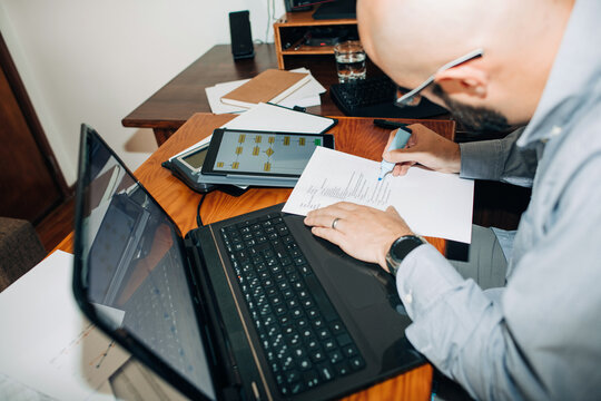 Man working with paper documents at his desk