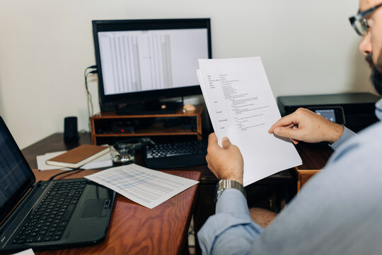 Man working with paper documents at his desk