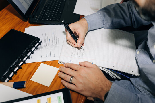 Man making notes while working at his desk