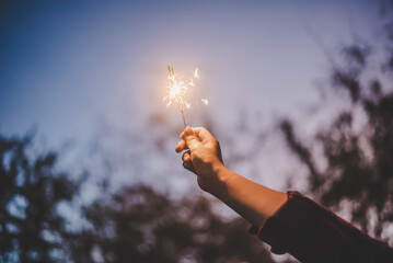 Female hand enjoy with burning Sparkler blast in new year party