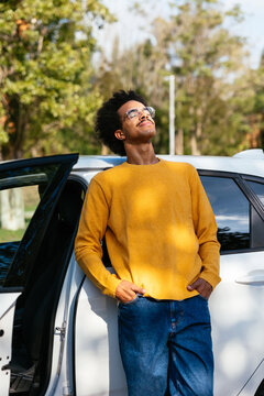 Driver leaning on car and breathing fresh air