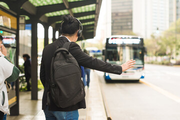 Man stoping the bus in a downtown street