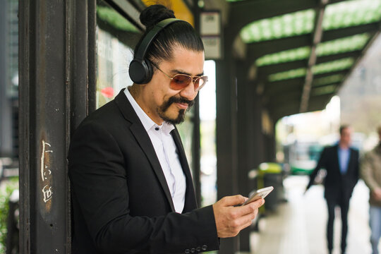 Business man watching memes in phone