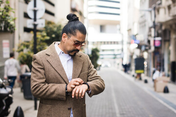 Latino man using smartwatch in the city