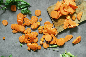 fresh carrots with green leaves on concrete background