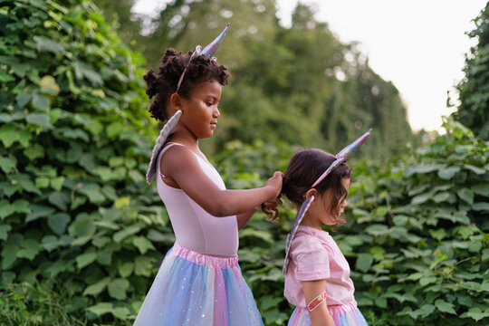 Two Girls Dressed As A Unicorn In Profile