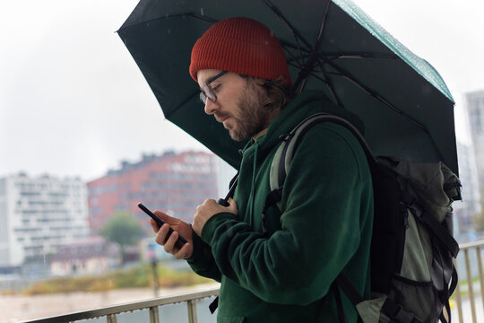 man under green umbrella